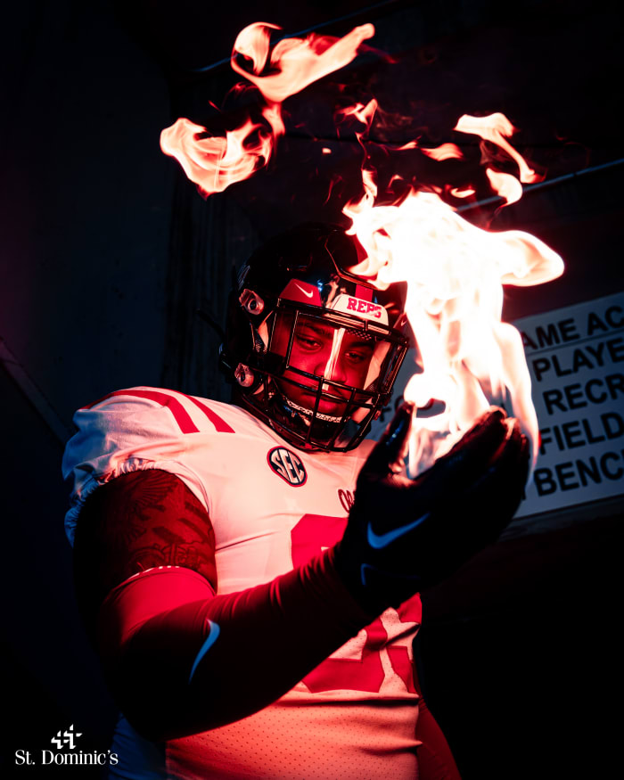 Ole Miss defensive lineman J.J. Pegues models the Rebels' uniform choice as they prepare to take on his former team on Saturday night.